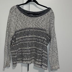 Gray sweater with black design.